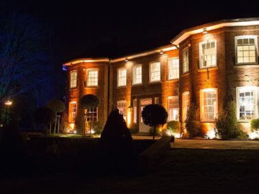 Delamere Manor at night lit up