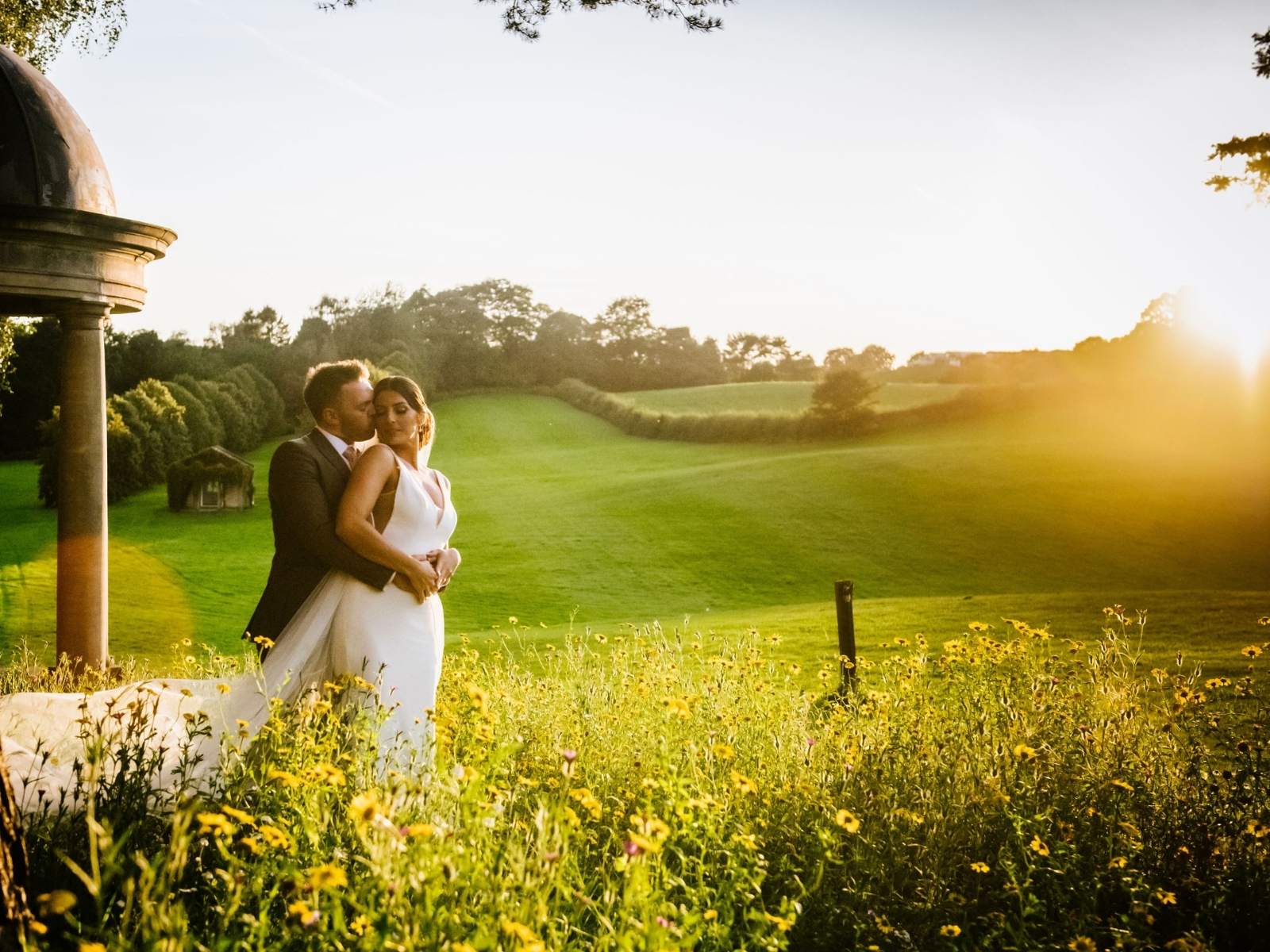 Couple hugging at the side of Folly