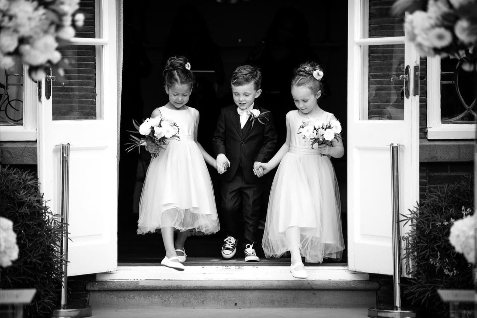 Page Boy And Flower Girls In Doorway On Terrace – Richardmilnes